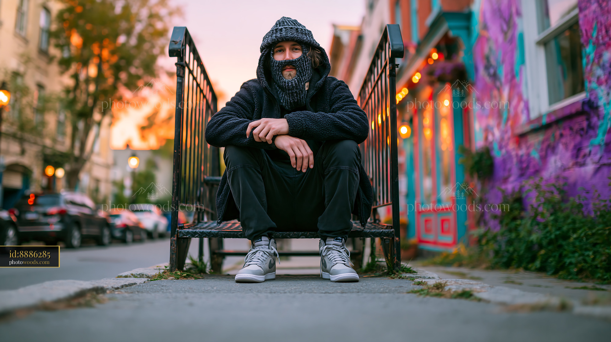 Young Man Wearing Knitted Balaclava Sitting on Urban Steps
