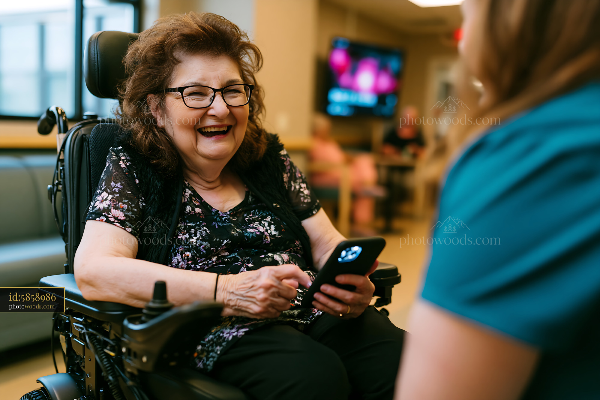 Laughing Grandmother Using Smartphone in Modern Wheelchair