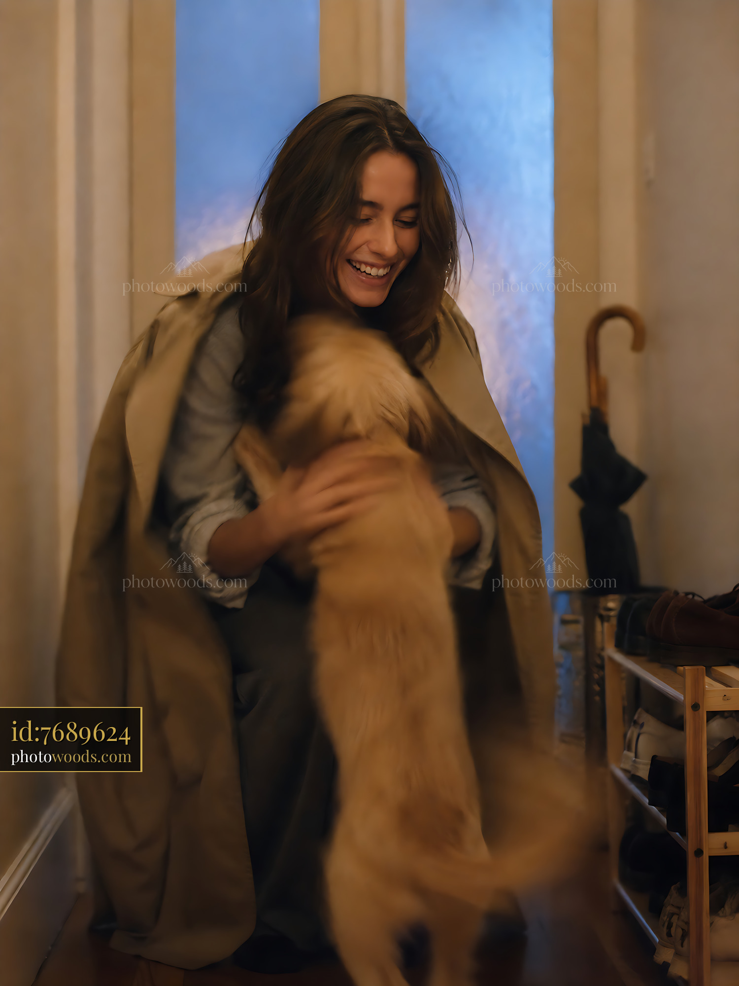Woman Smiling and Playing With Dog in Indoor Setting