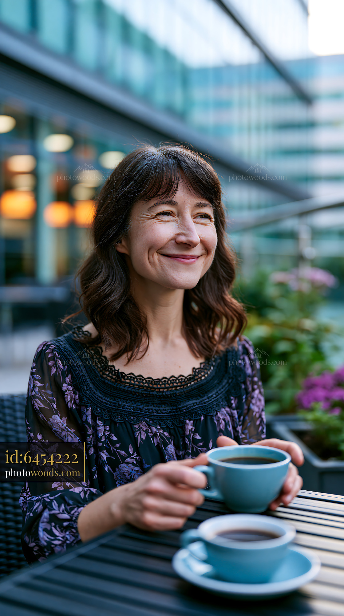 Smiling Woman Enjoying Coffee Outdoors at a Cafe