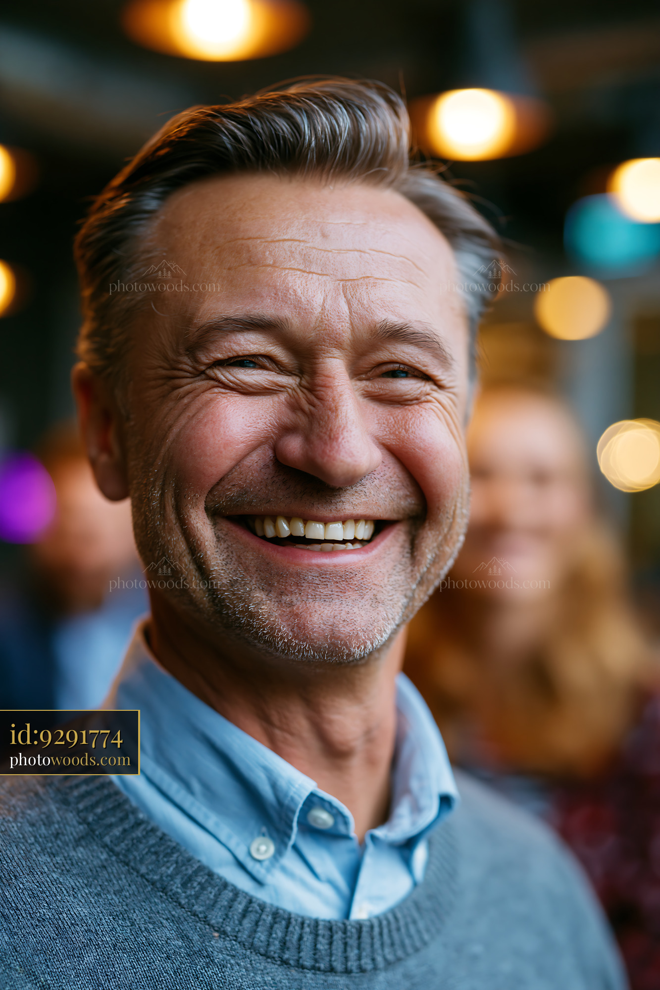 Smiling Man With Gray Hair Poses at a Social Gathering