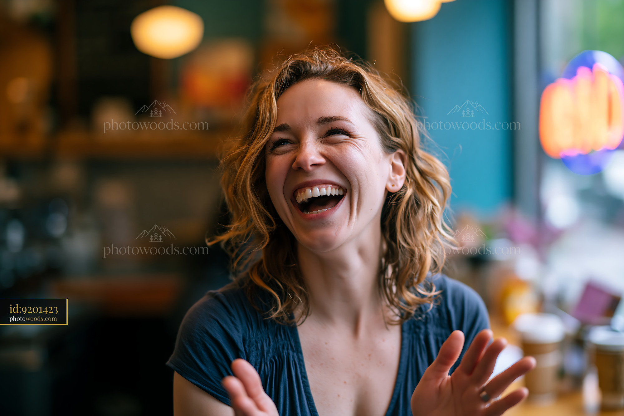 Joyful Teacher Using Sign Language While Laughing in a Cafe