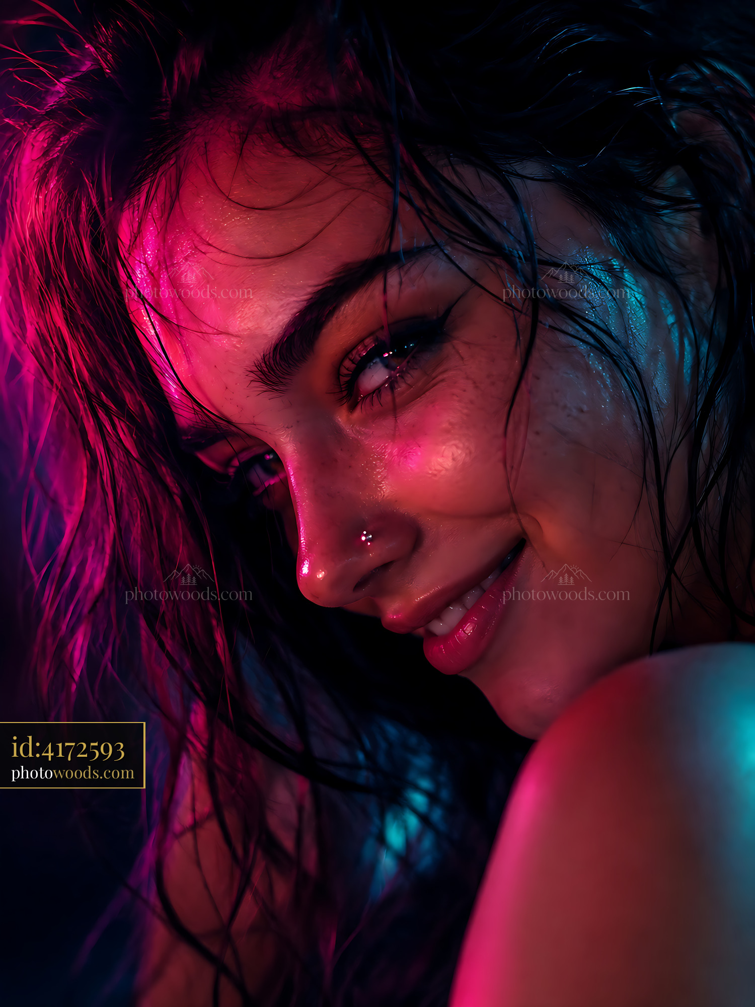Woman Smiling in Colorful Light With Water Droplets on Skin