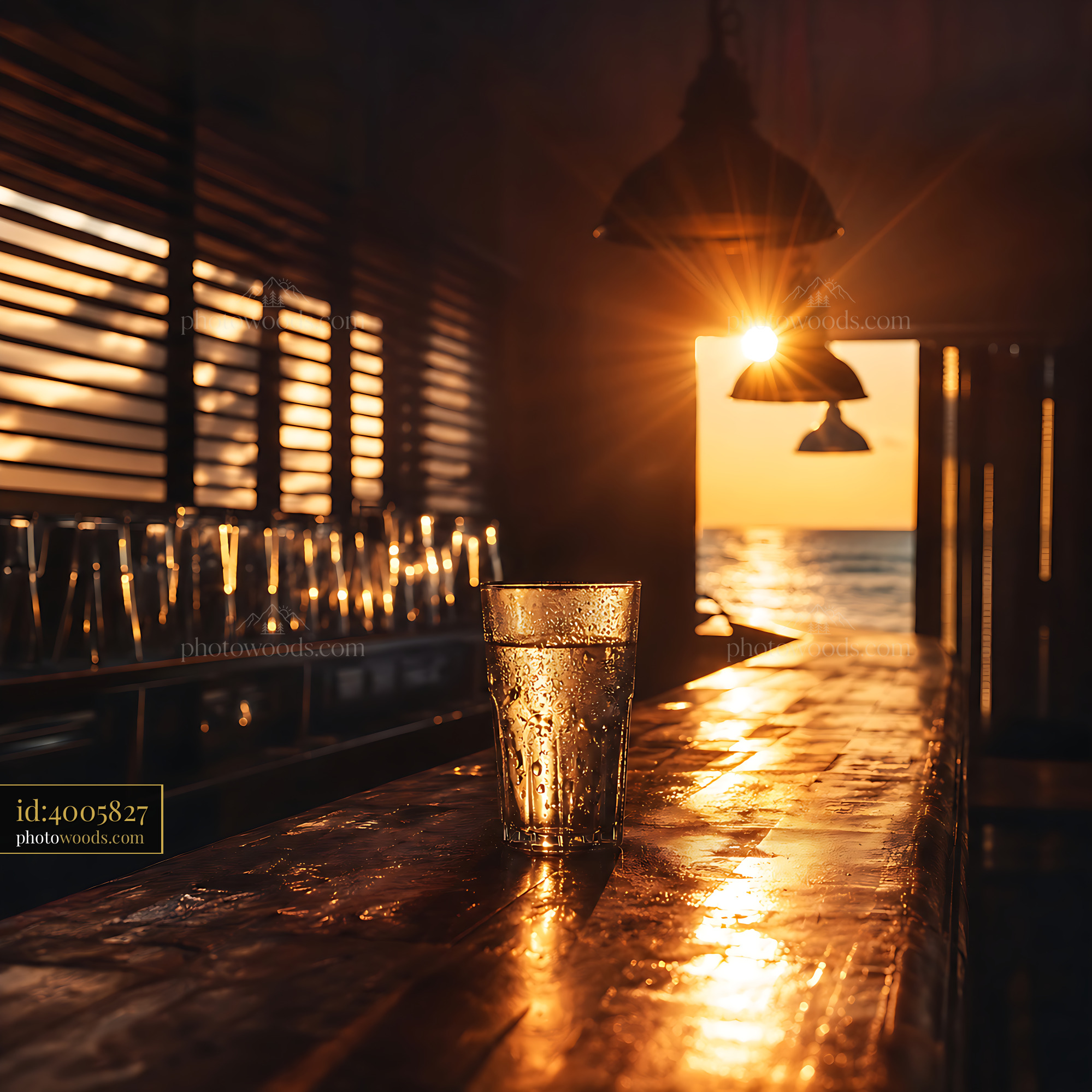 Glass of Water Sits on a Wooden Bar at Sunset Near the Ocean