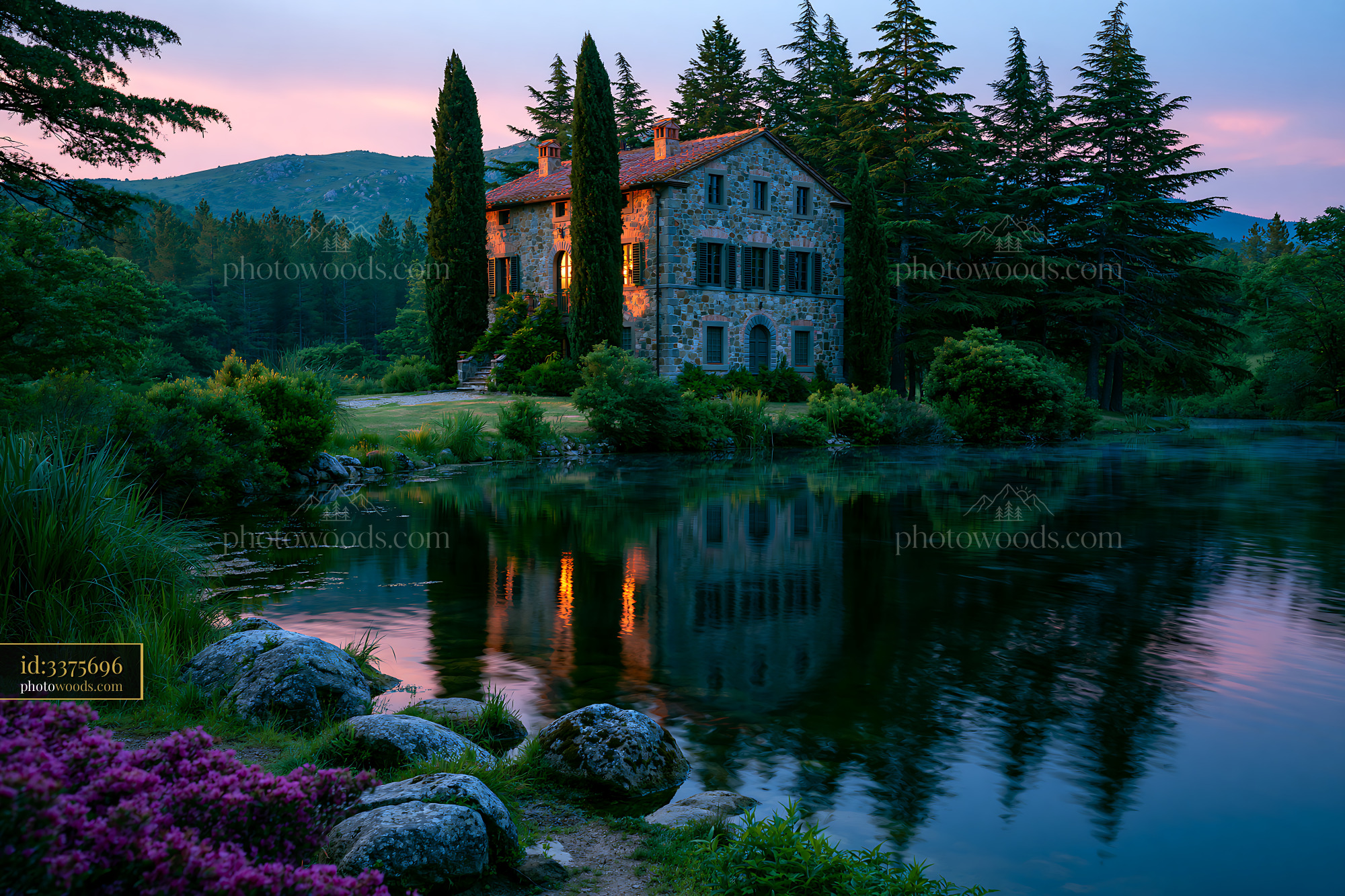 Tuscan Stone Farmhouse With Cypress Trees Near a Pond at Sunset