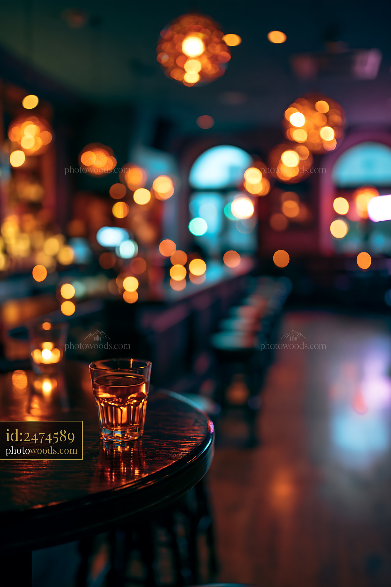Drink Sits on Bar Table in Dimly Lit Interior With Candles
