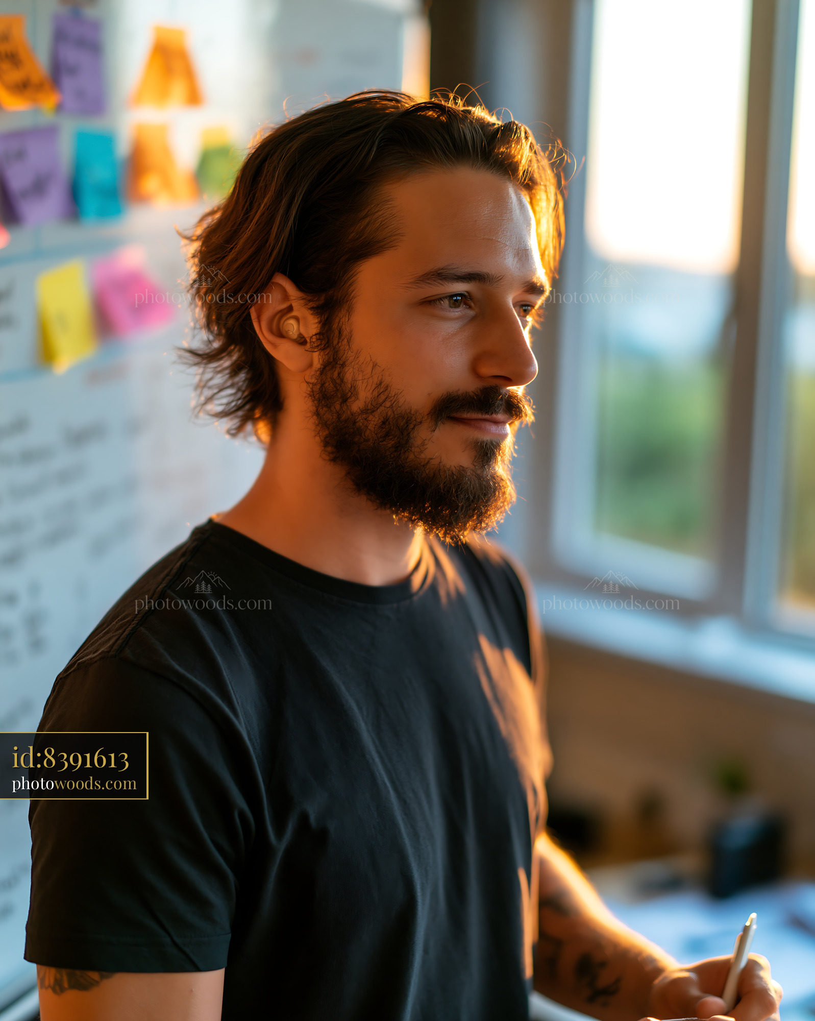Software Developer With Hearing Aid Working in Office During Sunset