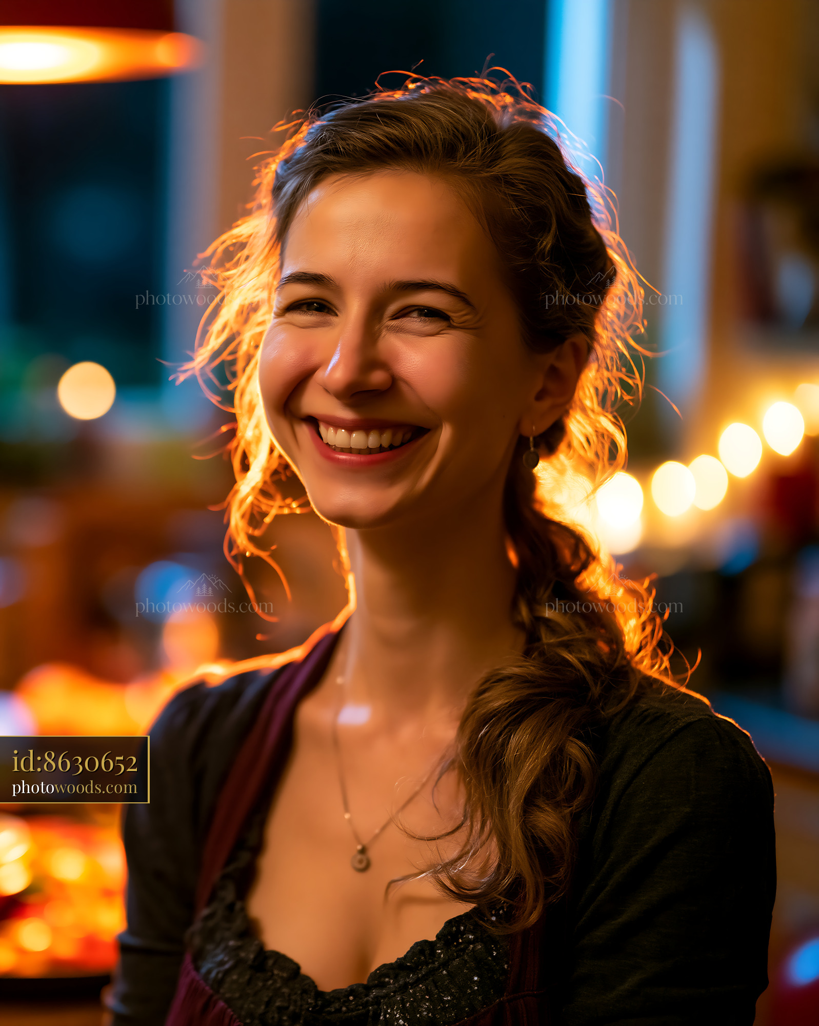 Woman Smiles in Kitchen With Warm Lights During Evening Time