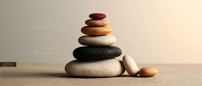 Balanced stack of smooth stones on a neutral surface