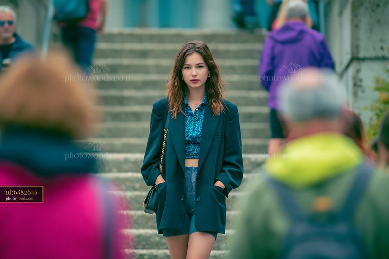 Woman in Oversized Blazer and Bike Shorts Walking Through Crowd