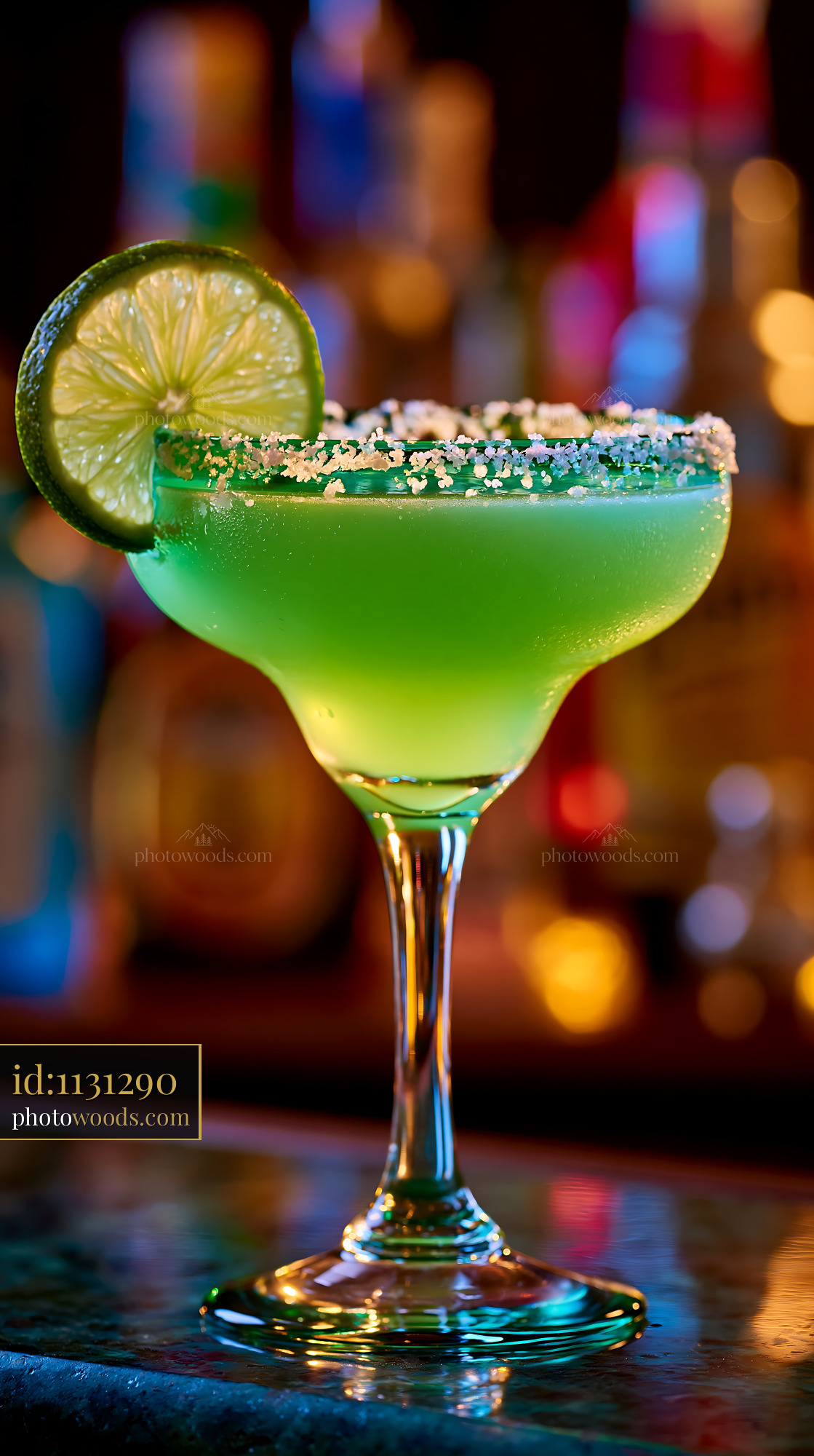 Green lime cocktail with salted rim and colorful bar bokeh