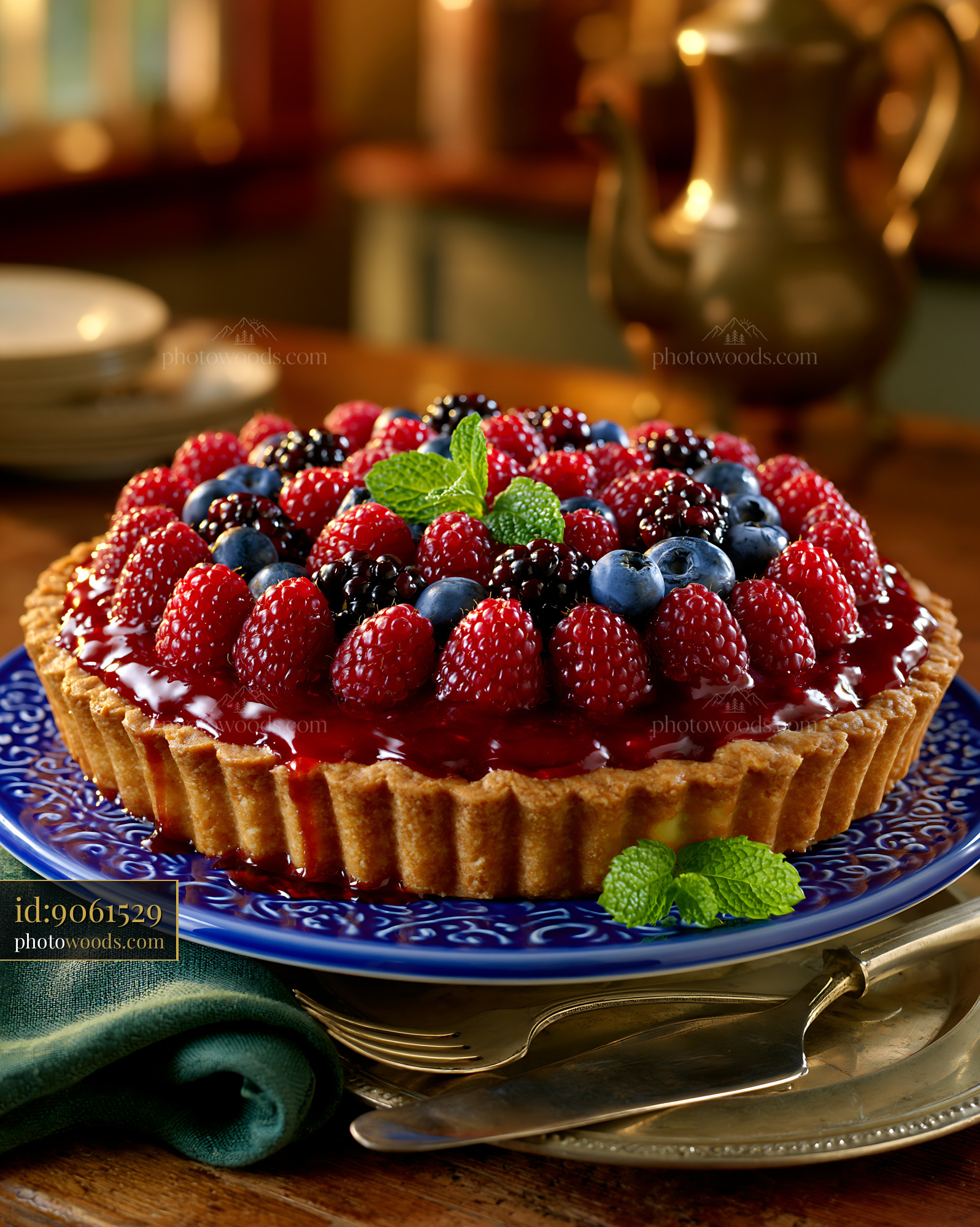 Fresh Berry Tart With Mint on a Blue Plate