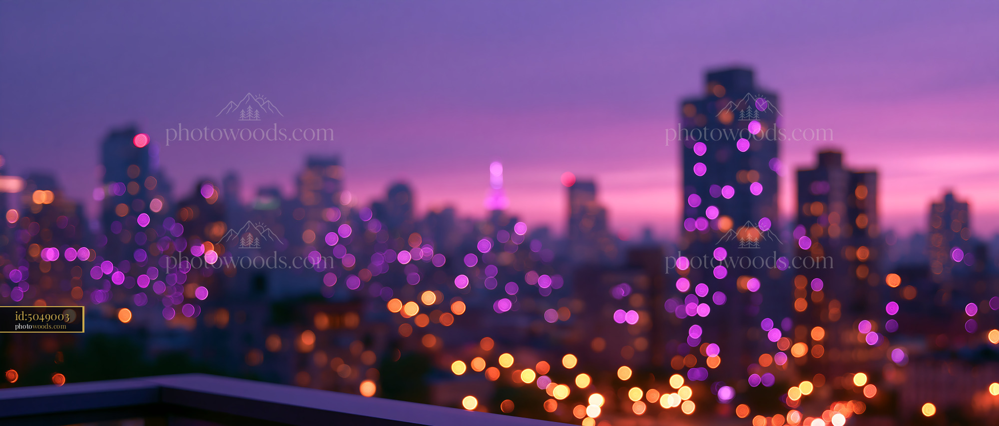 City Skyline Glows With Lights at Twilight Over Blurred Buildings