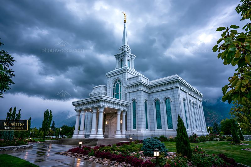 White temple with spire beneath dramatic storm clouds