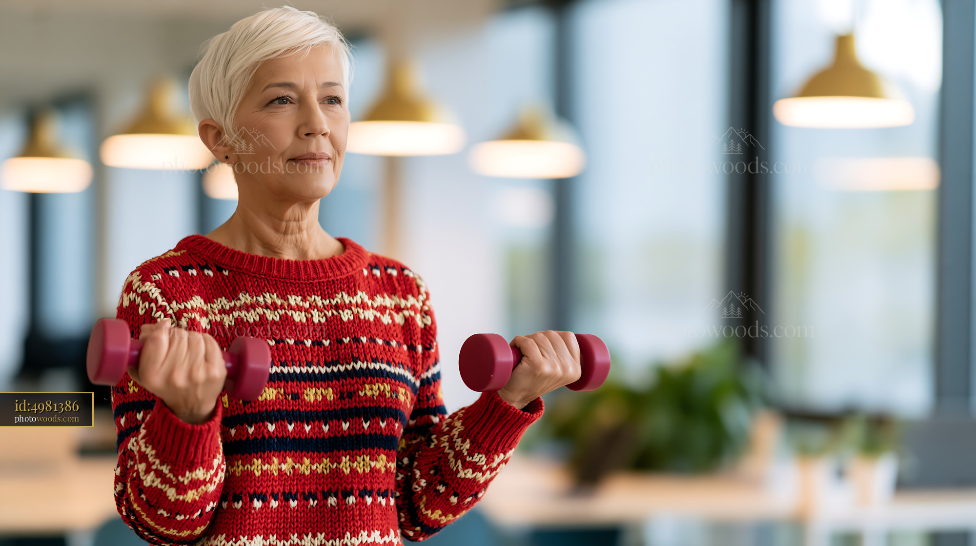 Older Woman Lifting Weights in Modern Gym Setting