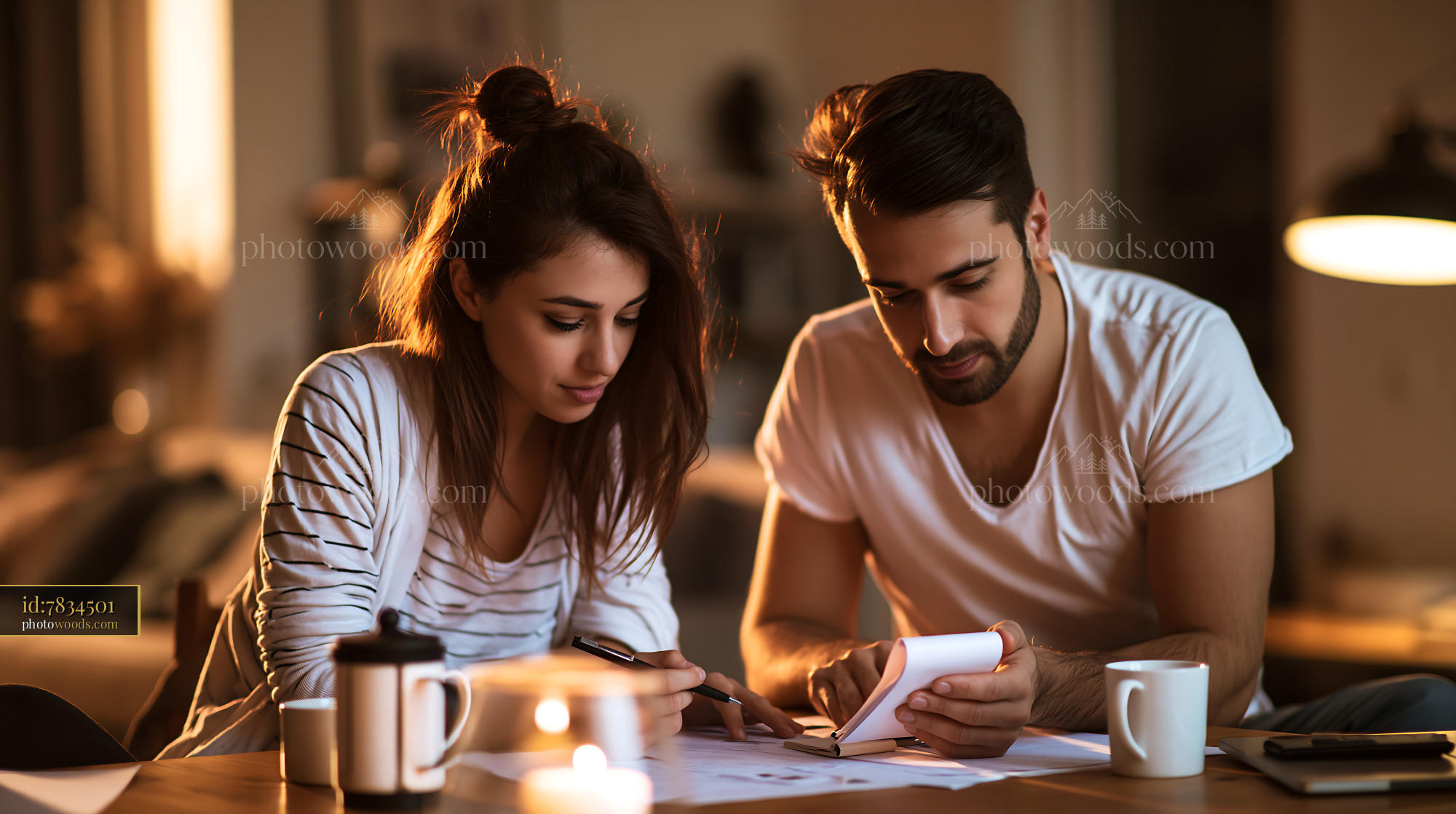 Young Couple Planning Monthly Budget at Home in the Evening