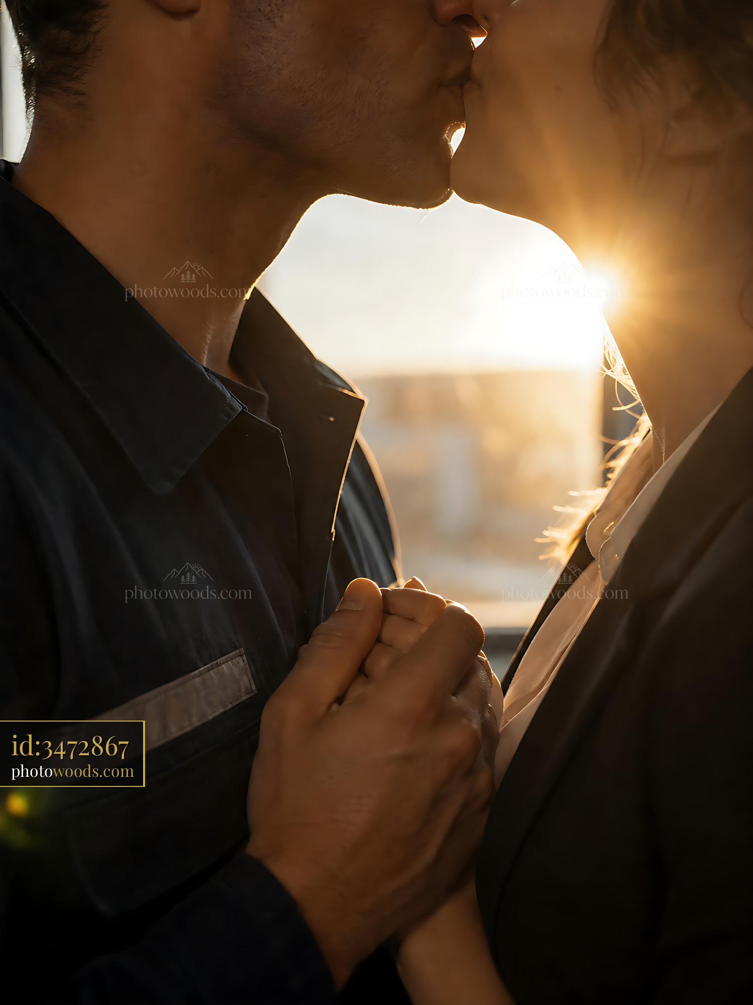 Couple Kissing While Holding Hands in Sunset Light