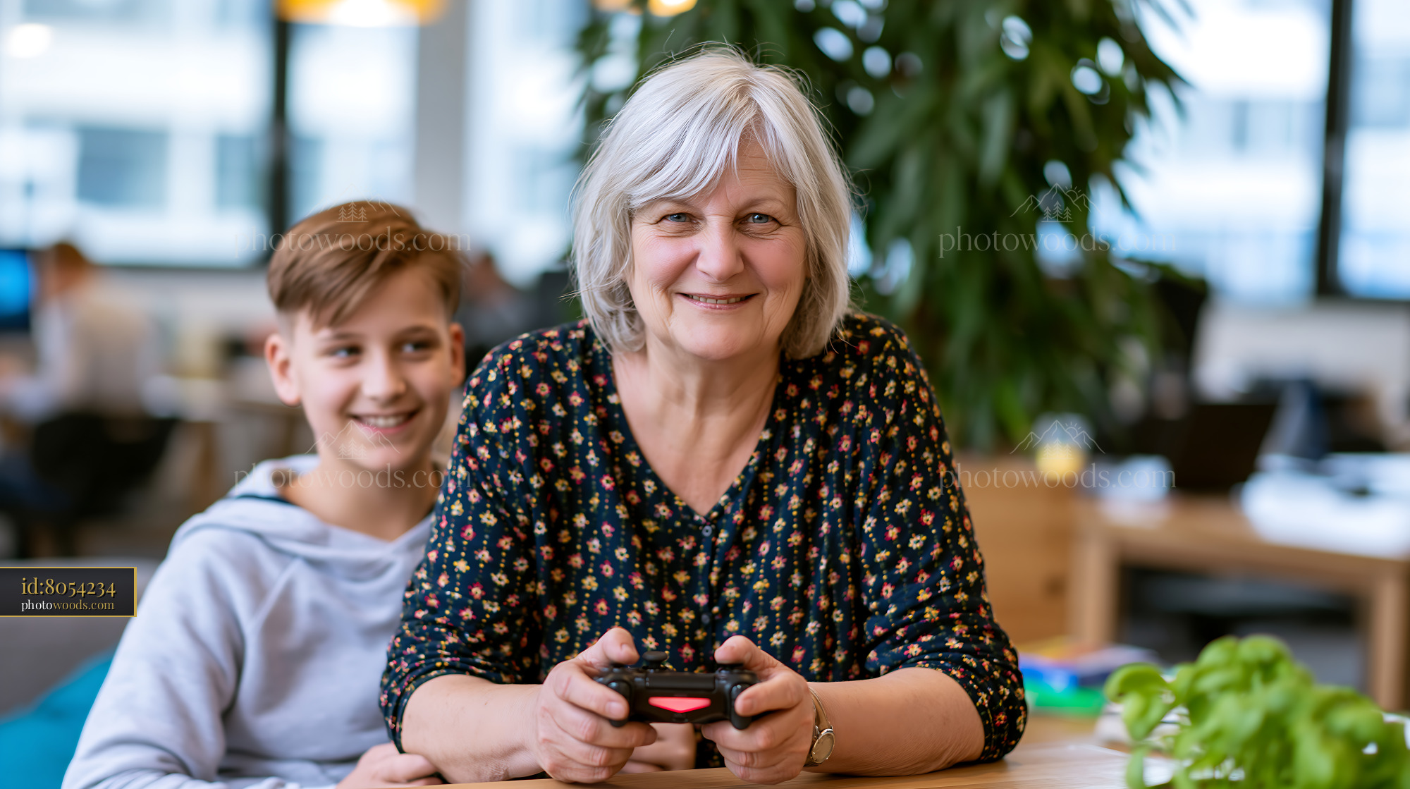 Older Woman Gaming With Grandson in a Modern Workspace