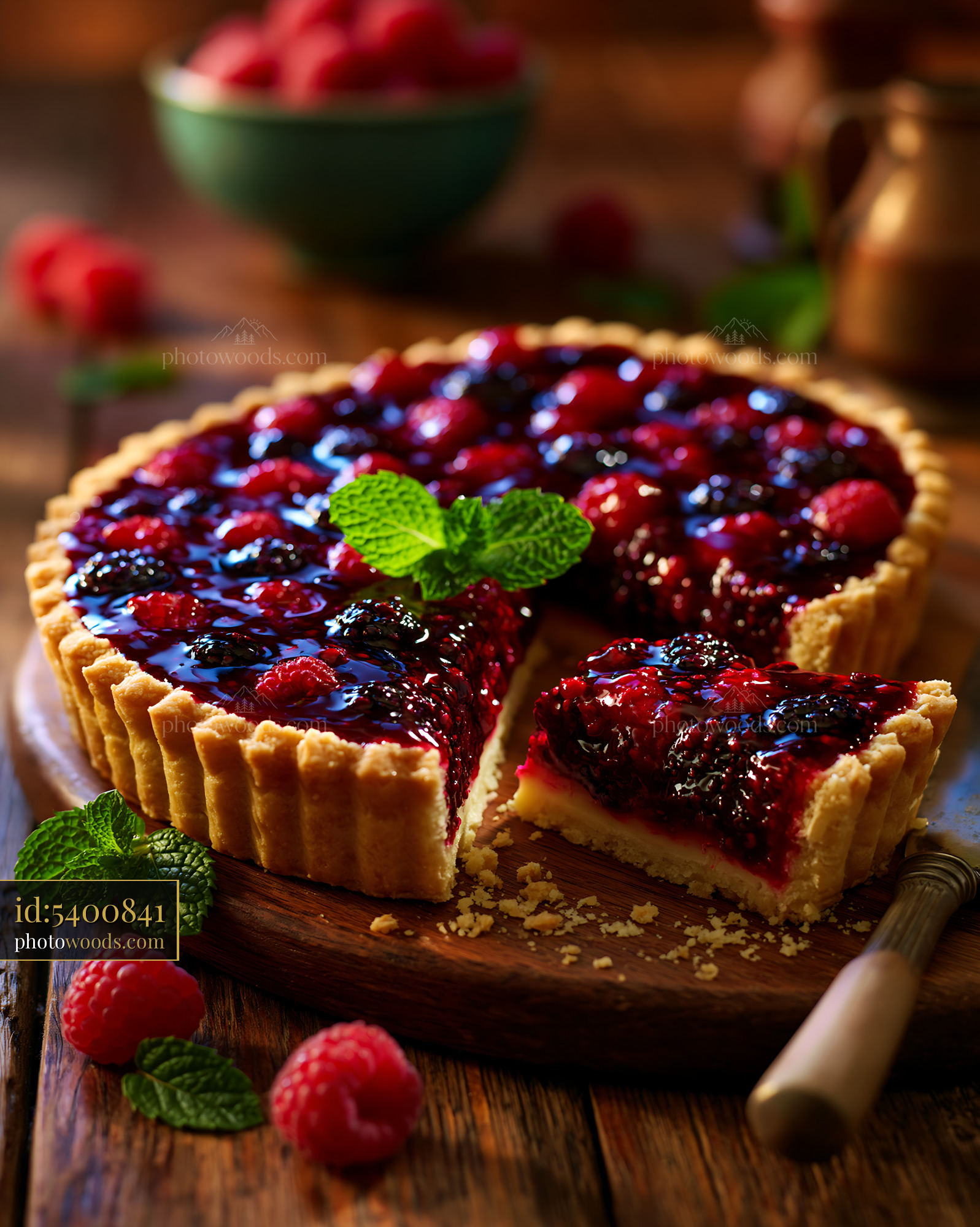 Fresh Berry Tart With Glossy Glaze and Mint on Wooden Table