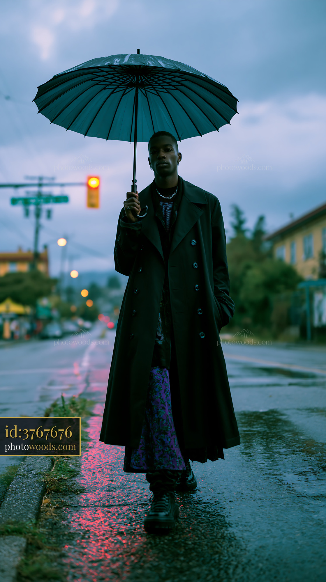 Tall Model Holding an Umbrella in a City Street During Evening