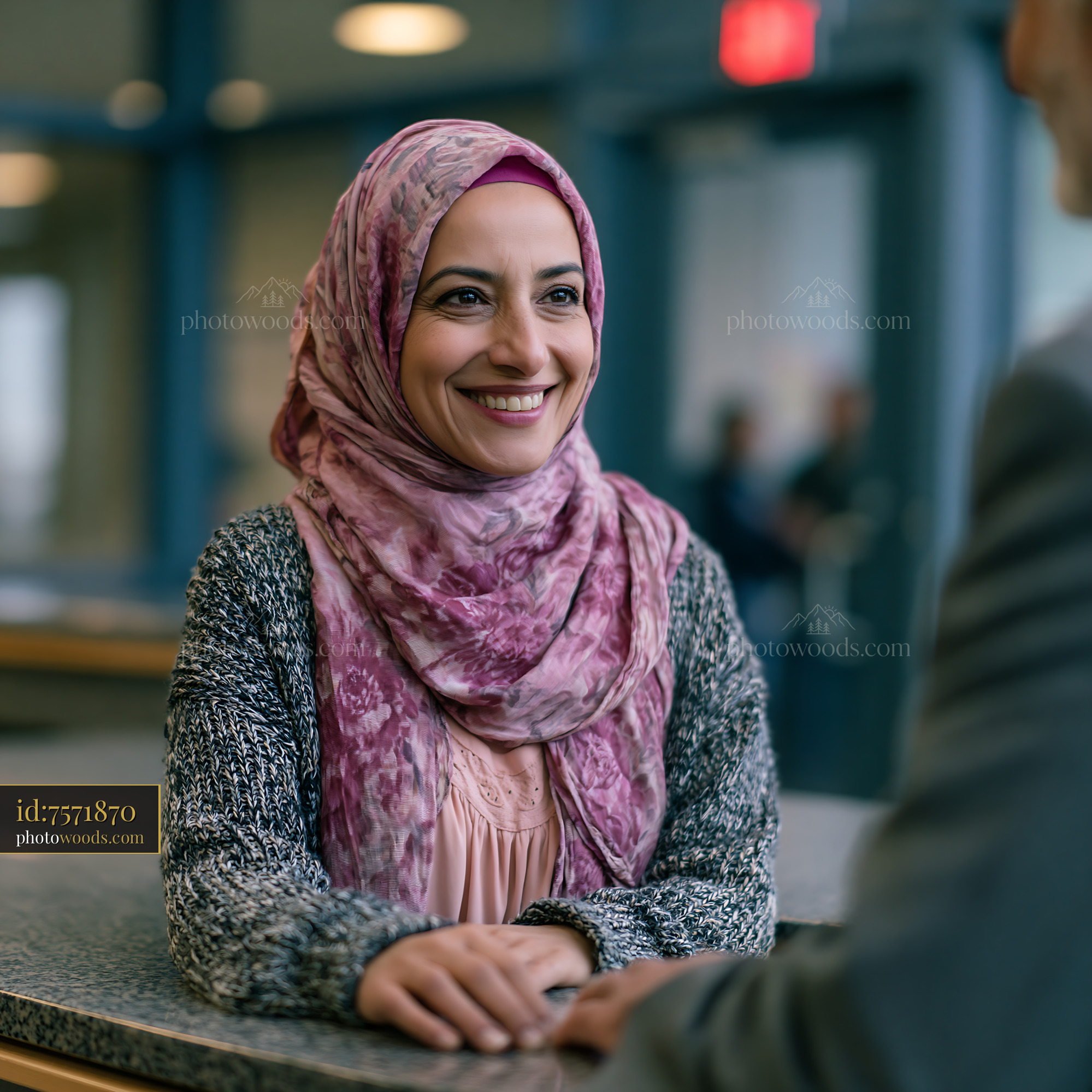 Female Engineer in Hijab Greeting Customer at Office Setting