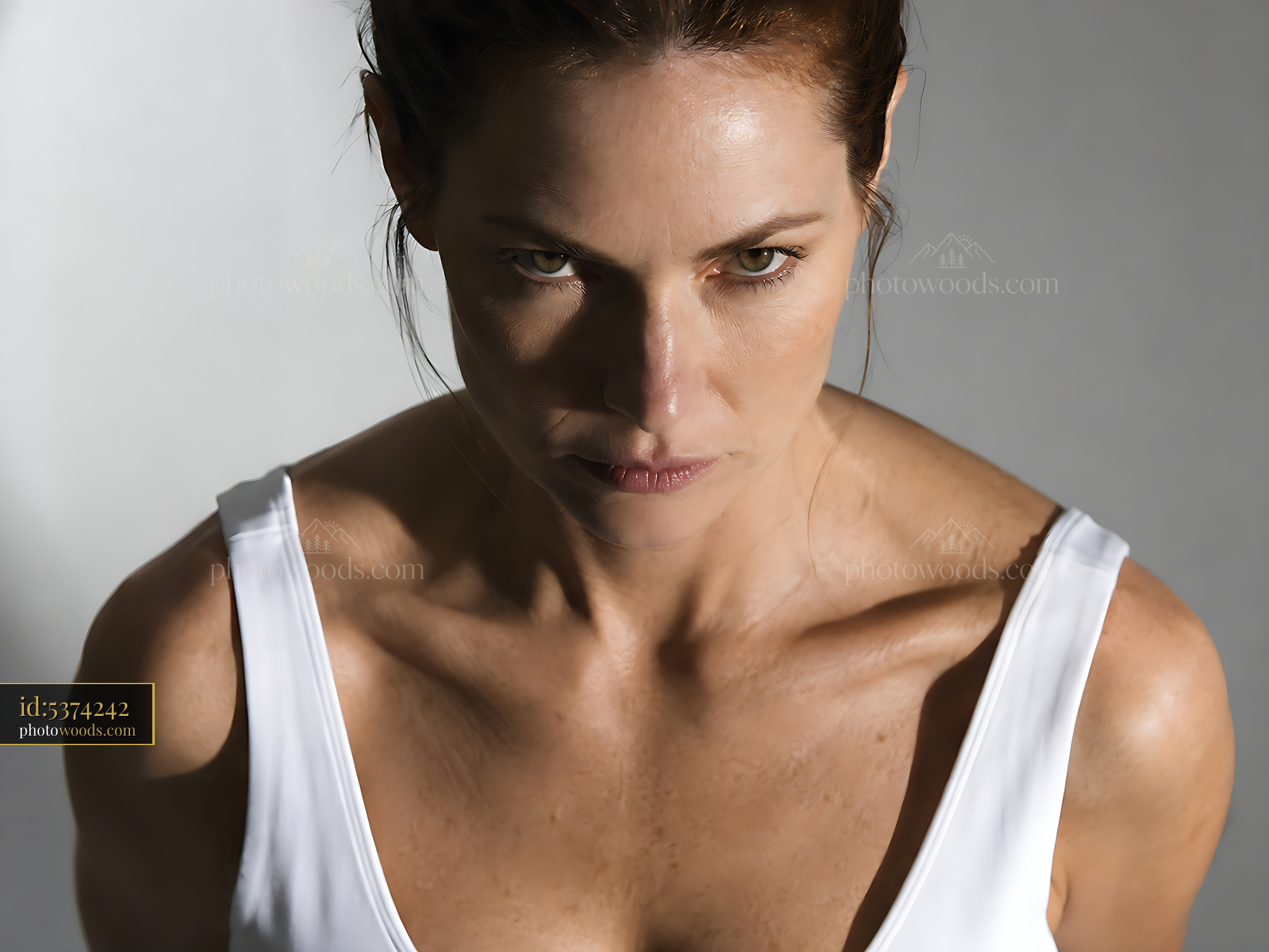 Woman With Focused Expression Against a Simple Background