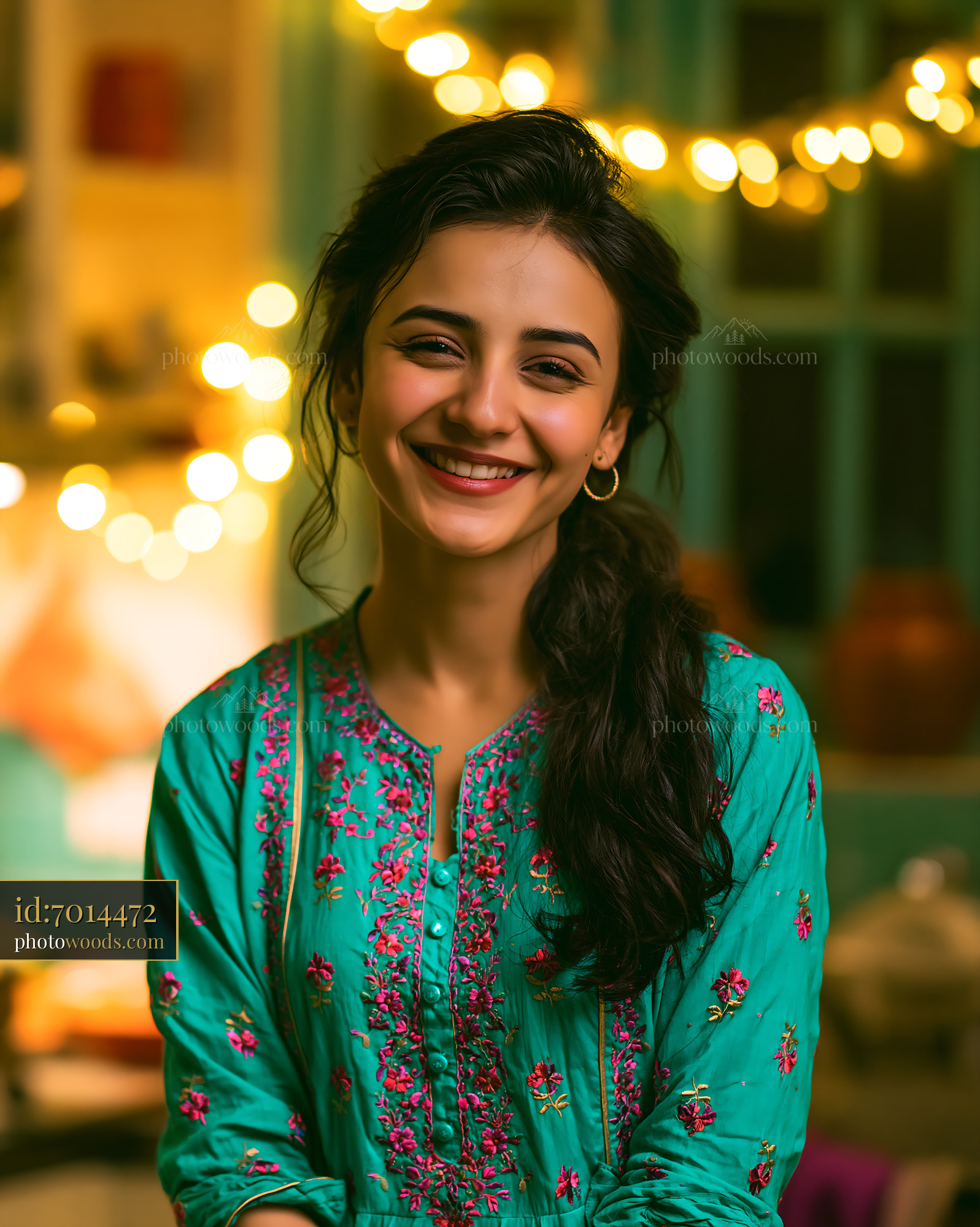 Smiling Woman in Traditional Dress With Lights in Background