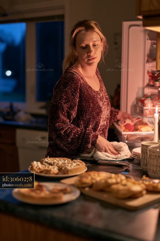 Woman cleaning dishes after a Christmas celebration
