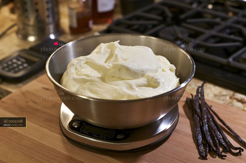 Cream dose with vanilla pods on a kitchen scale