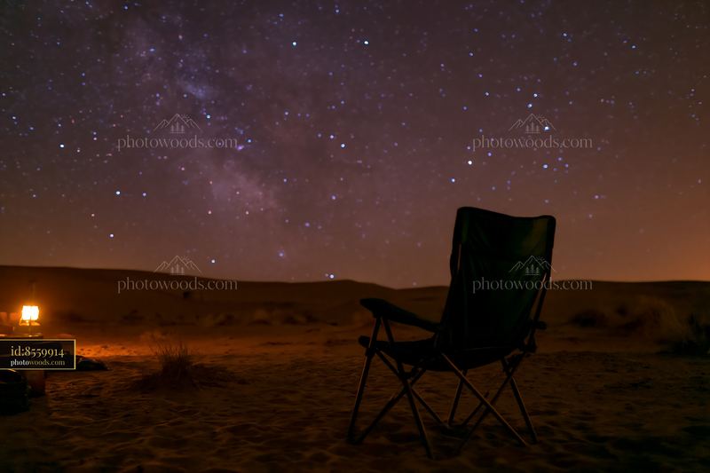 Starry night above a desert campsite under a clear sky