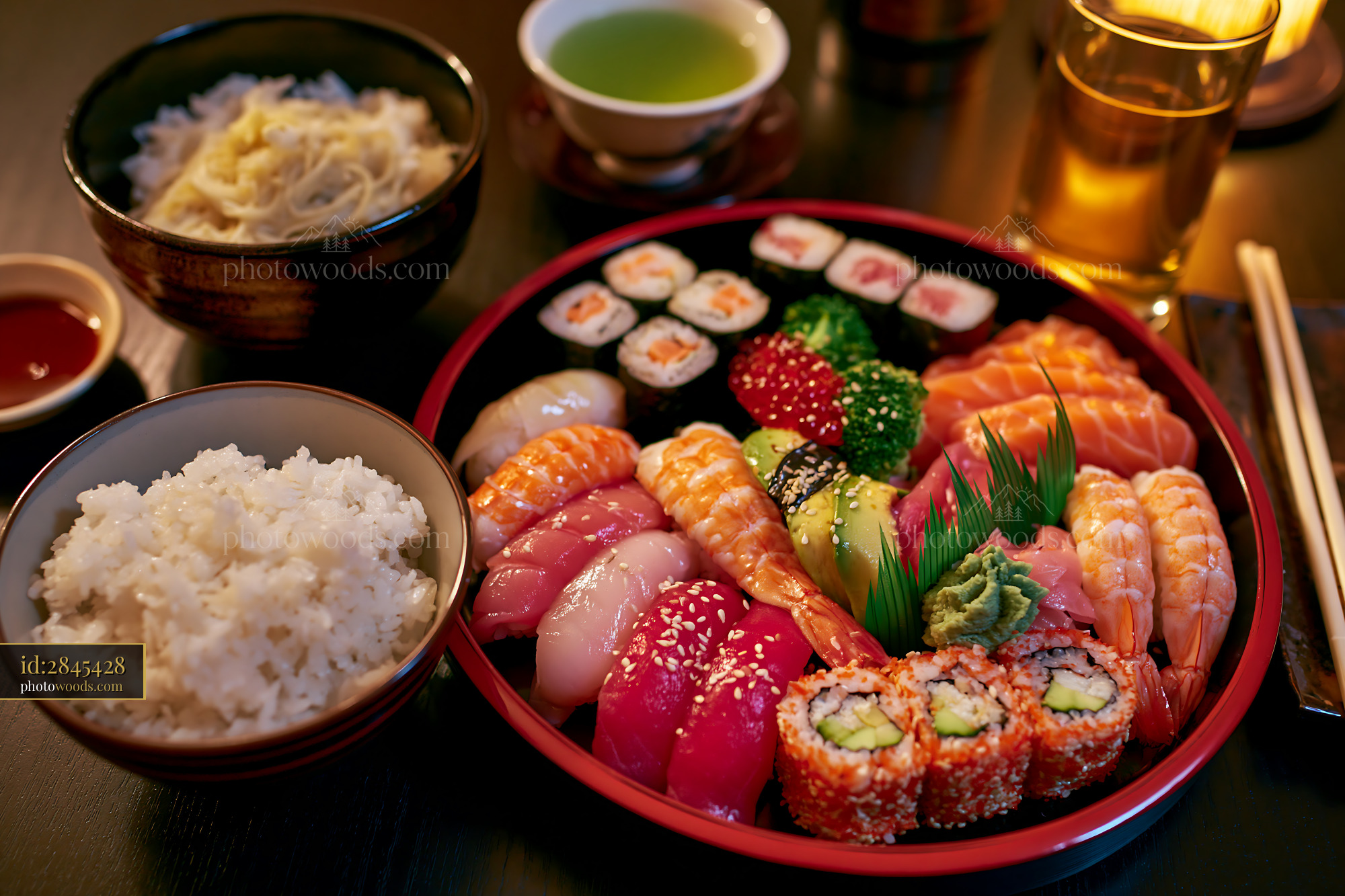 A colorful assortment of sushi types is arranged neatly on a round platter.