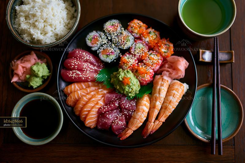 Sushi platter with rice and sides on a wooden table