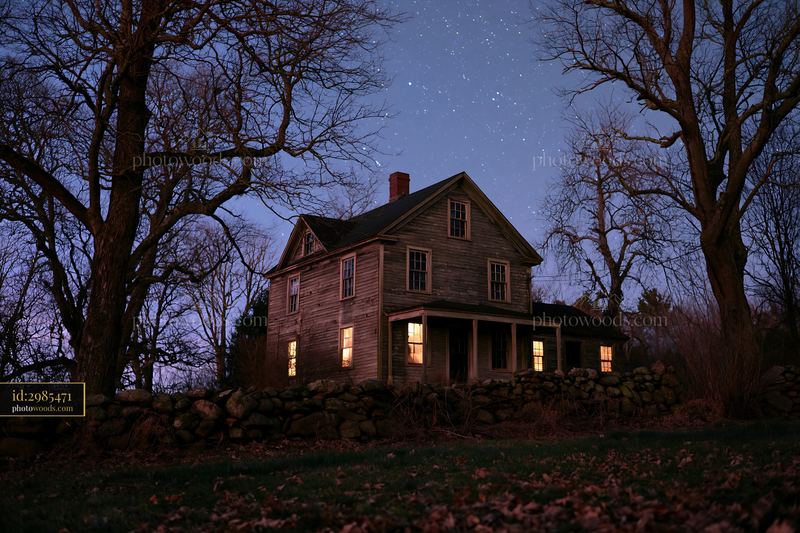 Country house stands under a clear starry sky at night