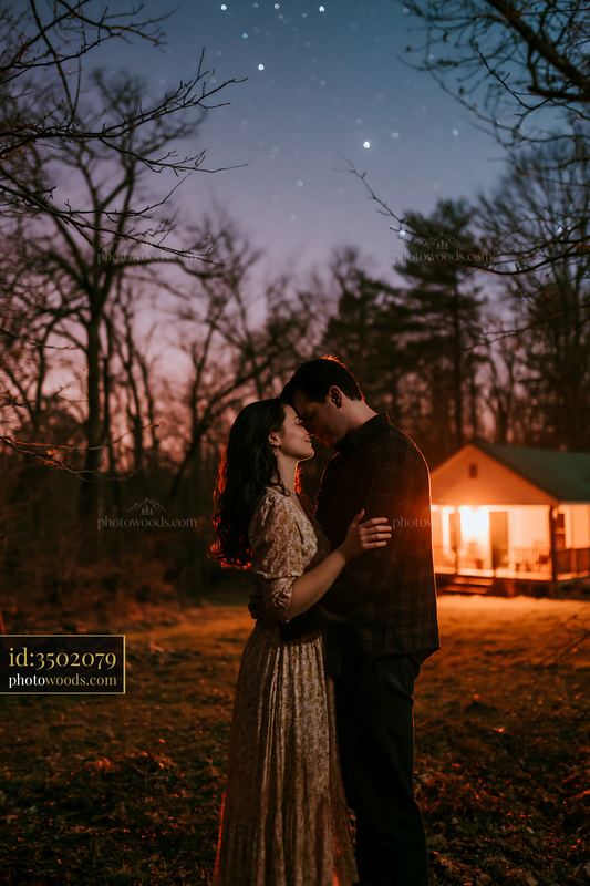 Couple embracing under a starry sky in a natural setting