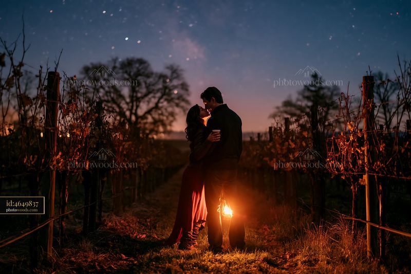 Couple shares hot drinks under stars in vineyard at night
