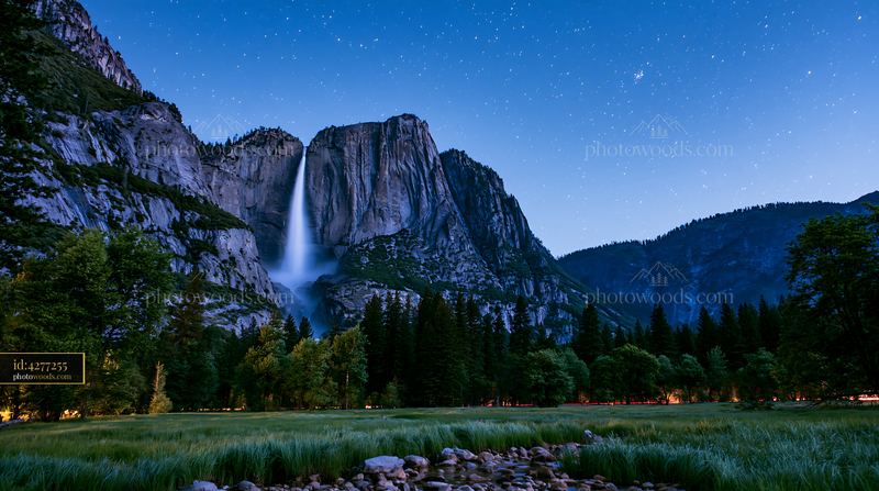 Couple enjoys time under stars near a waterfall at night