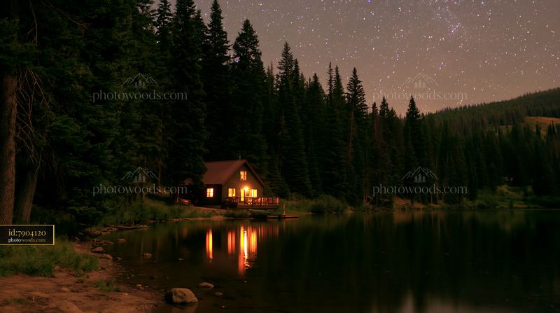 Holiday home under stars reflected in calm water
