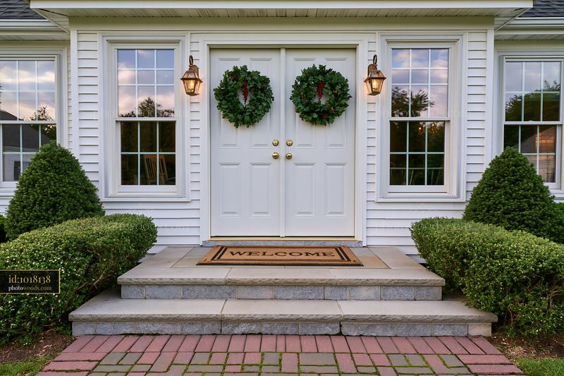 Front door with wreath and welcome doormat at a residential home