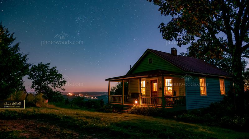 Cozy house with porch swing under clear night sky