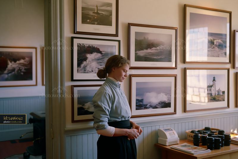 Lighthouse museum interior with displayed photographs and visitor