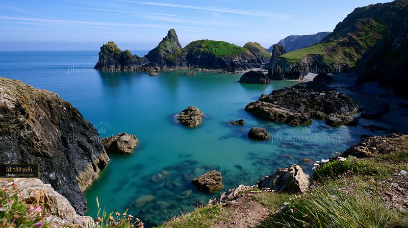 Coastline beneath dramatic cliffs and clear blue waters
