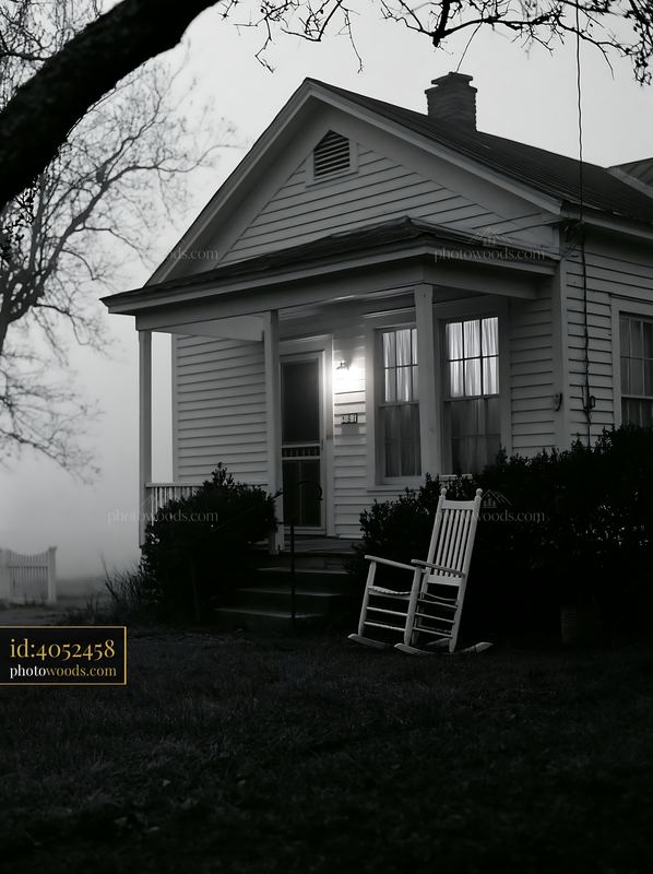 Rural farmhouse in morning fog near a rocking chair