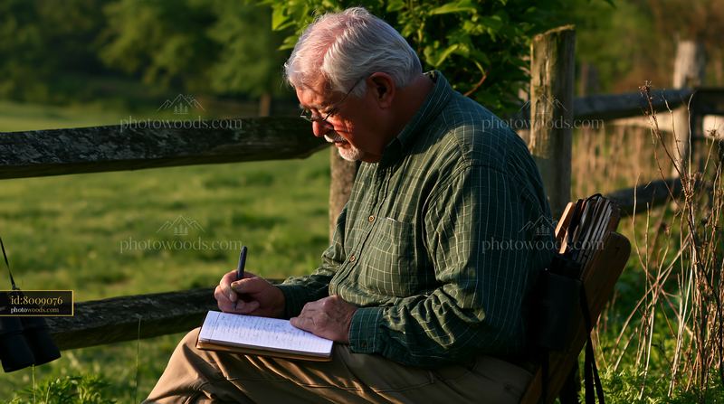 Senior person writing with hand tremor in outdoor setting