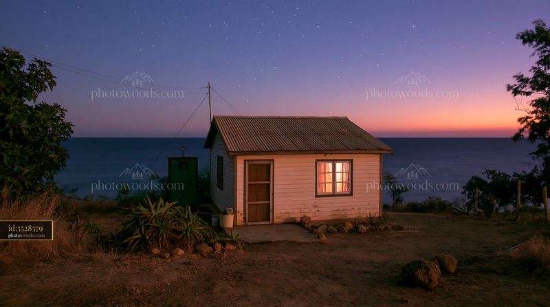 Coastal home with ocean horizon under stars at twilight
