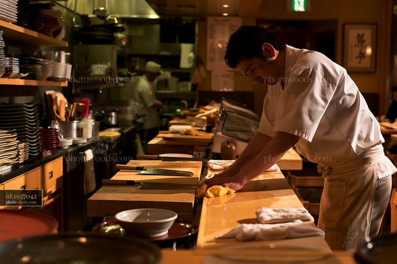 Sushi chef wiping counter in restaurant before opening service