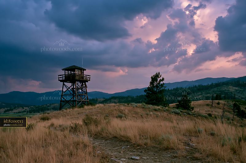 Thunderstorm over mountain range with fire lookout tower
