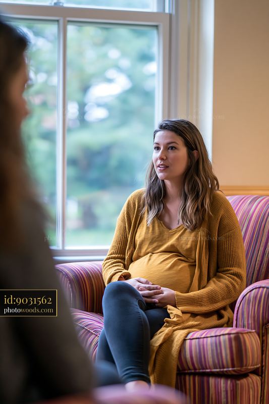 Therapist listening to bereaved person in cozy indoor setting
