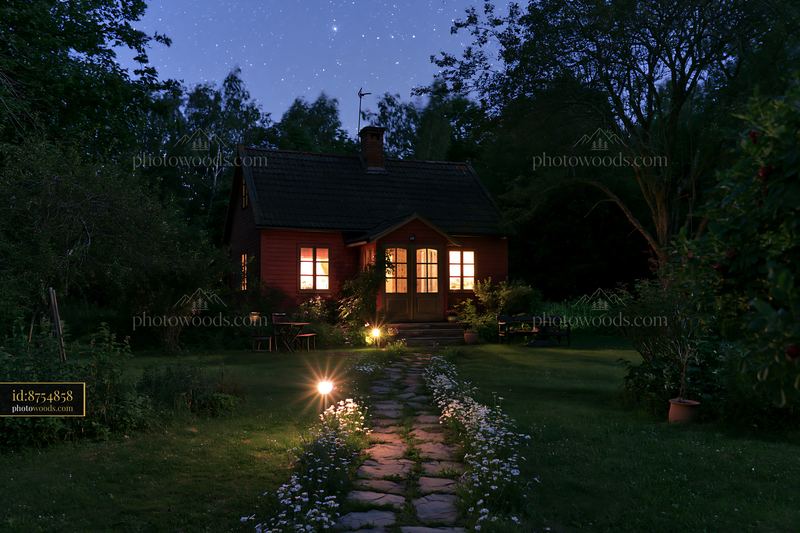 Cottage under stars with a stone path in a garden setting