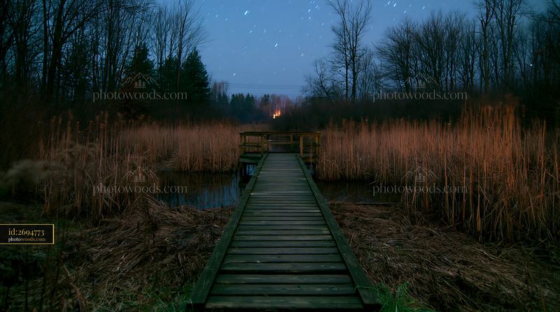 Capturing star trails over a lake at night