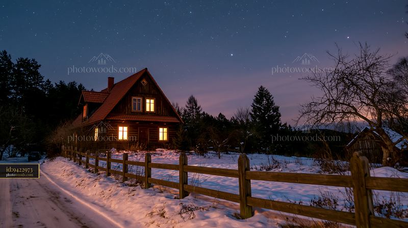 Snowy house under stars in a quiet rural setting